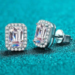Pair of 1.05 CTW emerald cut rectangular colorless moissanite halo stud earrings in 925 sterling silver with push back closures