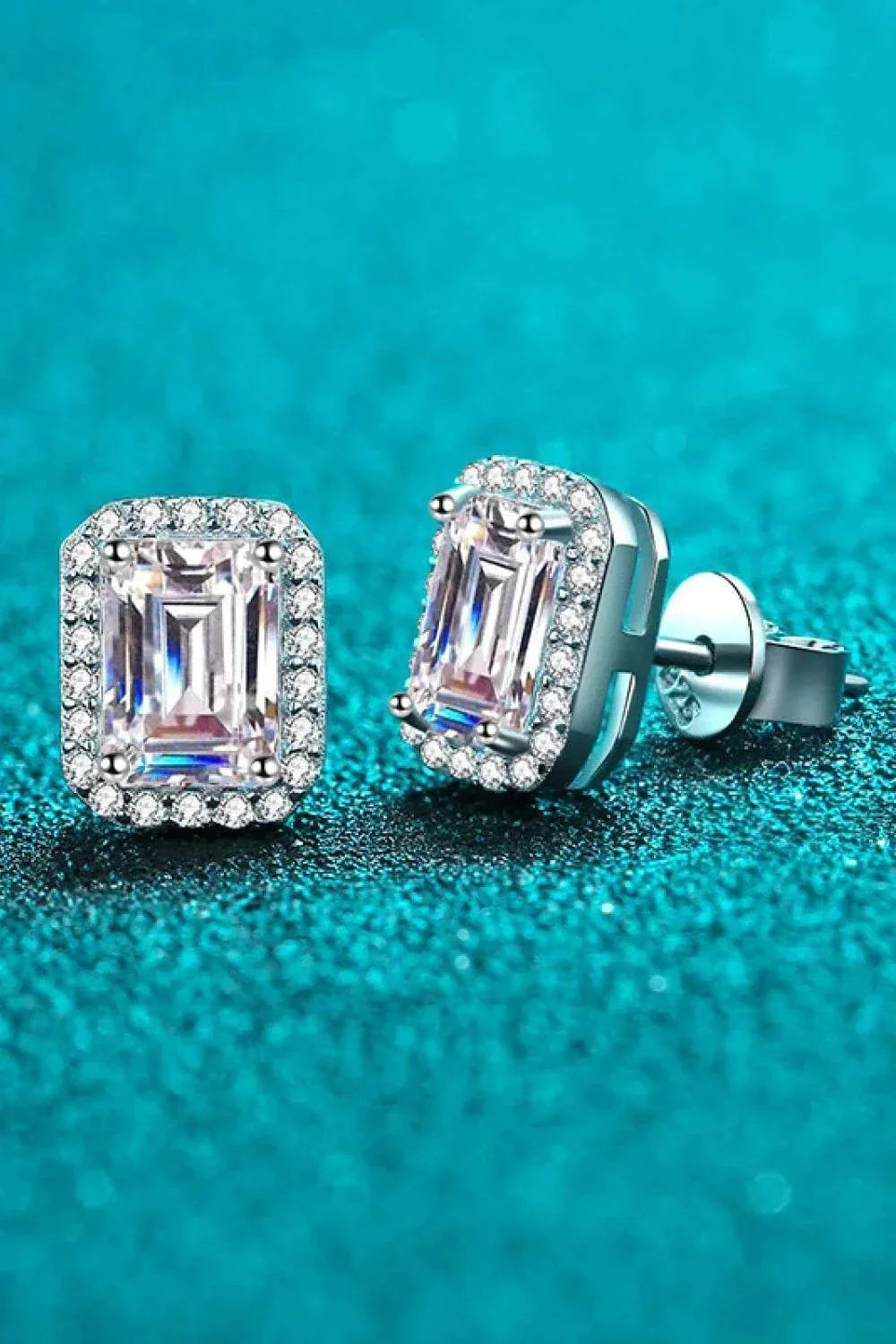 Pair of 1.05 CTW emerald cut rectangular colorless moissanite halo stud earrings in 925 sterling silver with push back closures