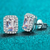 Pair of 1.05 CTW emerald cut rectangular colorless moissanite halo stud earrings in 925 sterling silver with push back closures
