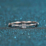 0.06 CTW DEW round brilliant cut moissanite ring in platinum plated S925 sterling silver with decorative oval band and cubic zirconia accents