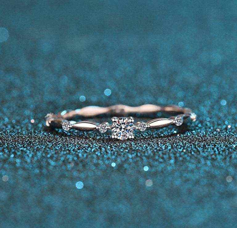 0.06 CTW DEW round brilliant cut moissanite ring in platinum plated S925 sterling silver with decorative oval band and cubic zirconia accents