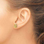 Shiny 14K yellow gold rose flower stud earrings with 2mm round lab-grown diamonds worn on ear