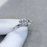 0.8 CTW DEW colorless round brilliant cut moissanite solitaire engagement ring in sterling silver with pavé accent stones