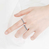 0.7 CTW DEW seven-stone round moissanite semi-eternity band ring in platinum plated S925 sterling silver on hand