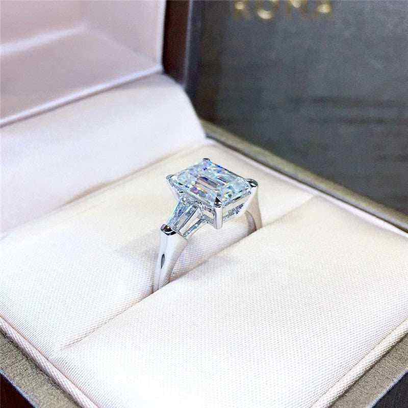 1.8 CTW DEW emerald cut moissanite three stone engagement ring with tapered baguette accents in 18K gold plated 925 sterling silver