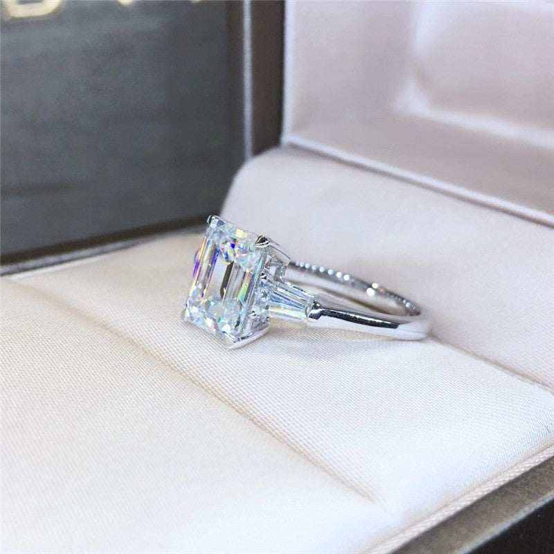 1.8 CTW DEW emerald cut moissanite three-stone engagement ring with tapered baguette side accents in 18K gold plated sterling silver