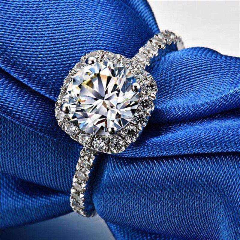 0.5 CTW DEW colorless round brilliant cut moissanite engagement ring with sterling silver pavé halo setting