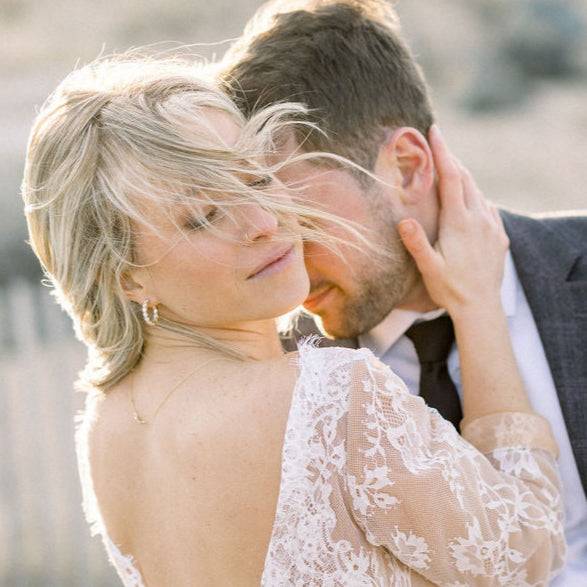 Close-up of a woman wearing Cairn 3 Carat Diamond Inside Outside Hoop Earrings with 14k gold and lab-grown diamonds, embracing a man in a romantic outdoor setting