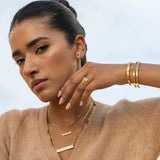 Rosera Gold Vermeil pendant necklace with raw uncut diamonds layered on a sterling silver base worn by a woman