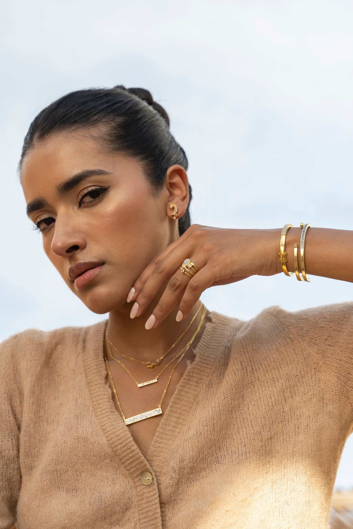 Rosera Gold Vermeil pendant necklace with raw uncut diamonds layered on a sterling silver base worn by a woman