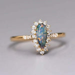 18K yellow gold engagement ring with Australian black opal and halo diamonds