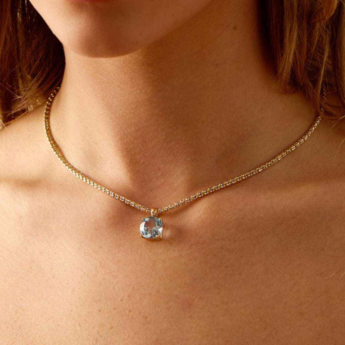 Horizon Necklace with 14k gold chain and London Blue Topaz pendant worn on neck
