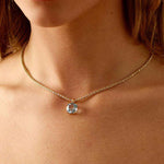 Horizon Necklace with 14k gold chain and London Blue Topaz pendant worn on neck