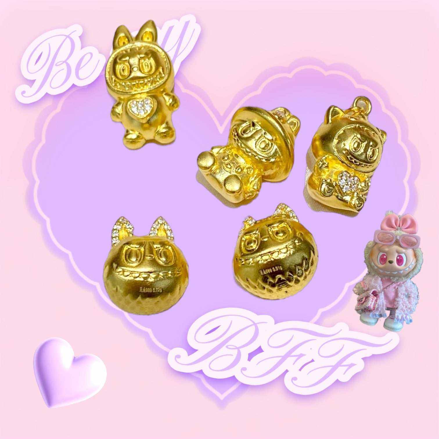 24K gold Labubu-inspired collectible doll-head pendants with sparkling moissanite gemstones on a pink and purple heart background