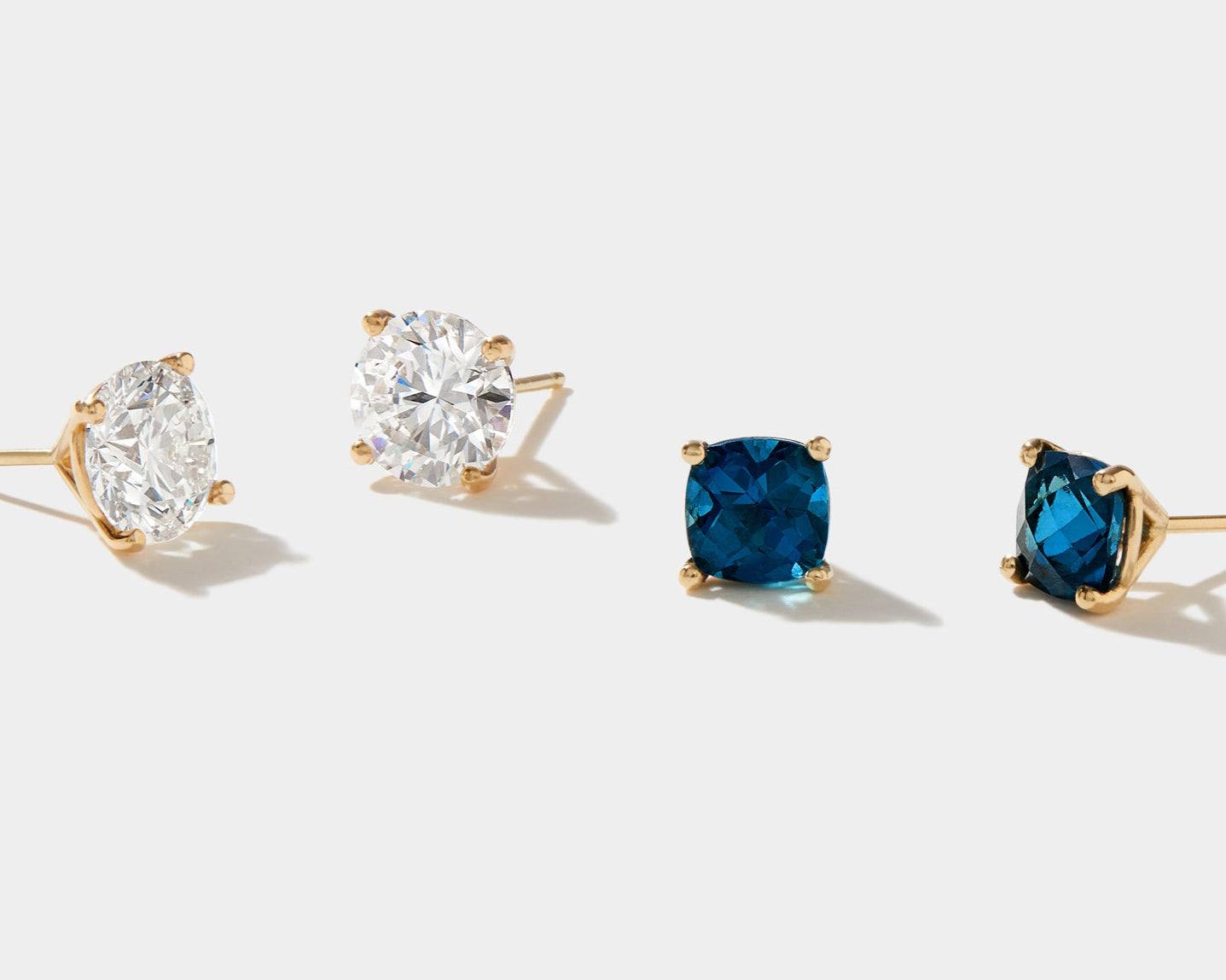 Lab grown diamond stud earrings in 14k gold with round white and blue stones.
