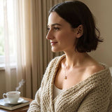 Woman wearing sterling silver necklace with single white freshwater pearl pendant