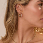 Close-up of woman wearing Cairn 3 Carat Diamond inside outside hoop earrings in 14k gold