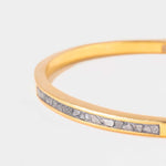 Slim Hapur Gold Vermeil Bangle with embedded raw diamond pieces on a gold band