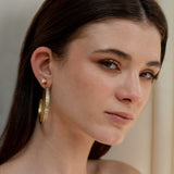 Woman wearing Hapur Gold Vermeil Hoop Earrings with sliced raw uncut diamonds and 18k gold layer