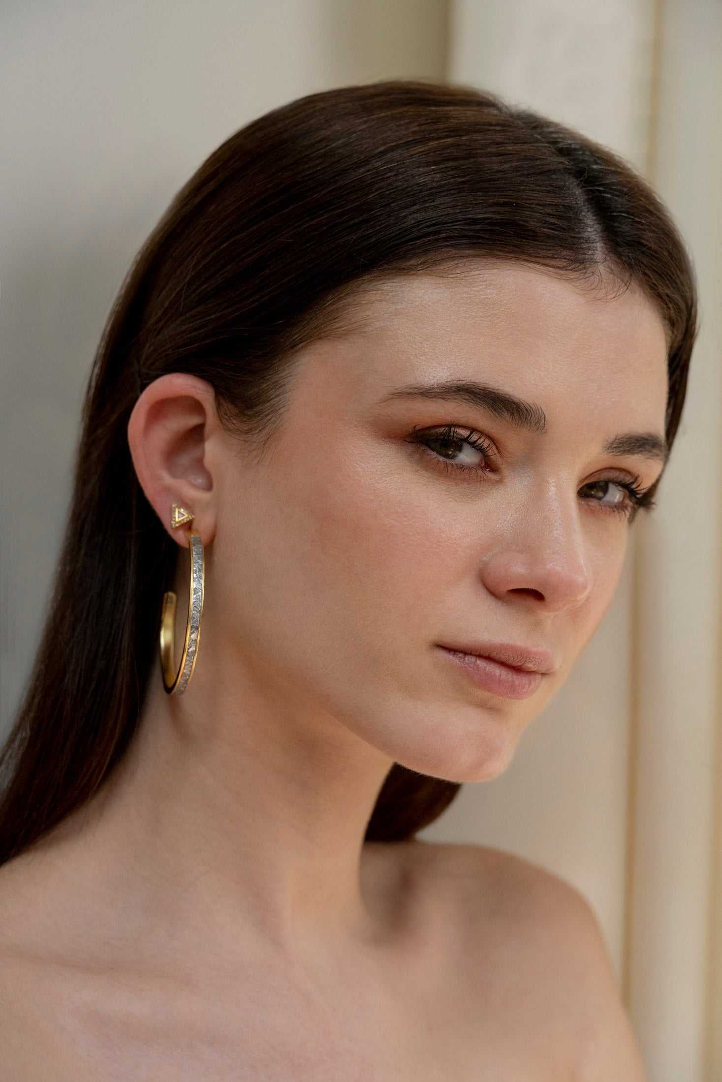 Woman wearing Hapur Gold Vermeil Hoop Earrings with sliced raw uncut diamonds and 18k gold layer