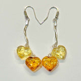 Translucent golden brown multi heart shaped Baltic amber dangling drop earrings with 925 sterling silver hooks
