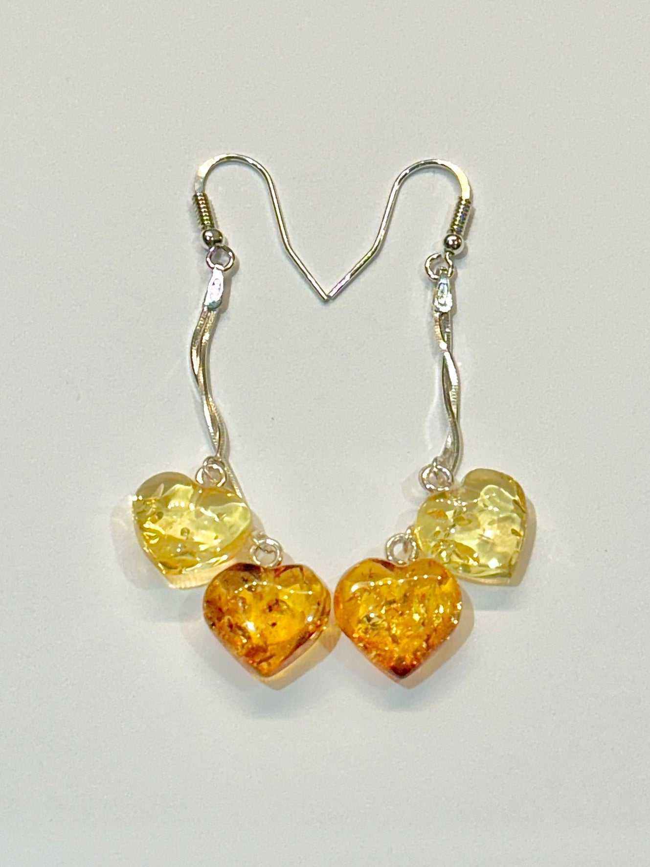 Translucent golden brown multi heart shaped Baltic amber dangling drop earrings with 925 sterling silver hooks