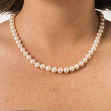 18-inch freshwater pearl strand necklace with white pearls on model's neck