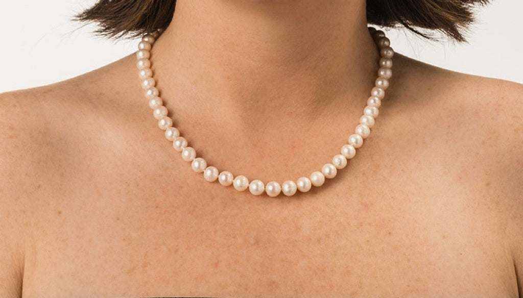 18-inch freshwater pearl strand necklace with white pearls on model's neck