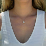 14K yellow gold pendant with 4.2 CT oval moissanite center and 4 natural alexandrite stones in vintage inspired mirror style worn on a delicate chain