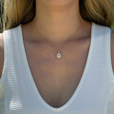 14K yellow gold pendant with 4.2 CT oval moissanite center and 4 natural alexandrite stones in vintage inspired mirror style worn on a delicate chain