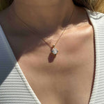 14K yellow gold pendant with 4.2 CT oval moissanite and 4 natural alexandrite stones in a vintage inspired mirror style worn on a delicate chain