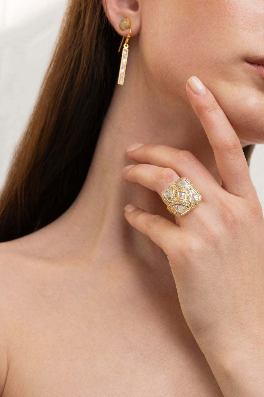 Miladi Small Gold Vermeil Earrings with raw uncut diamonds, long geometric dangling design, worn on ear.