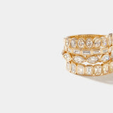 Stacked gold rings featuring bezel-set marquise and emerald-cut lab-grown diamonds in a half eternity design, including the Sankaty Bezel Ring.