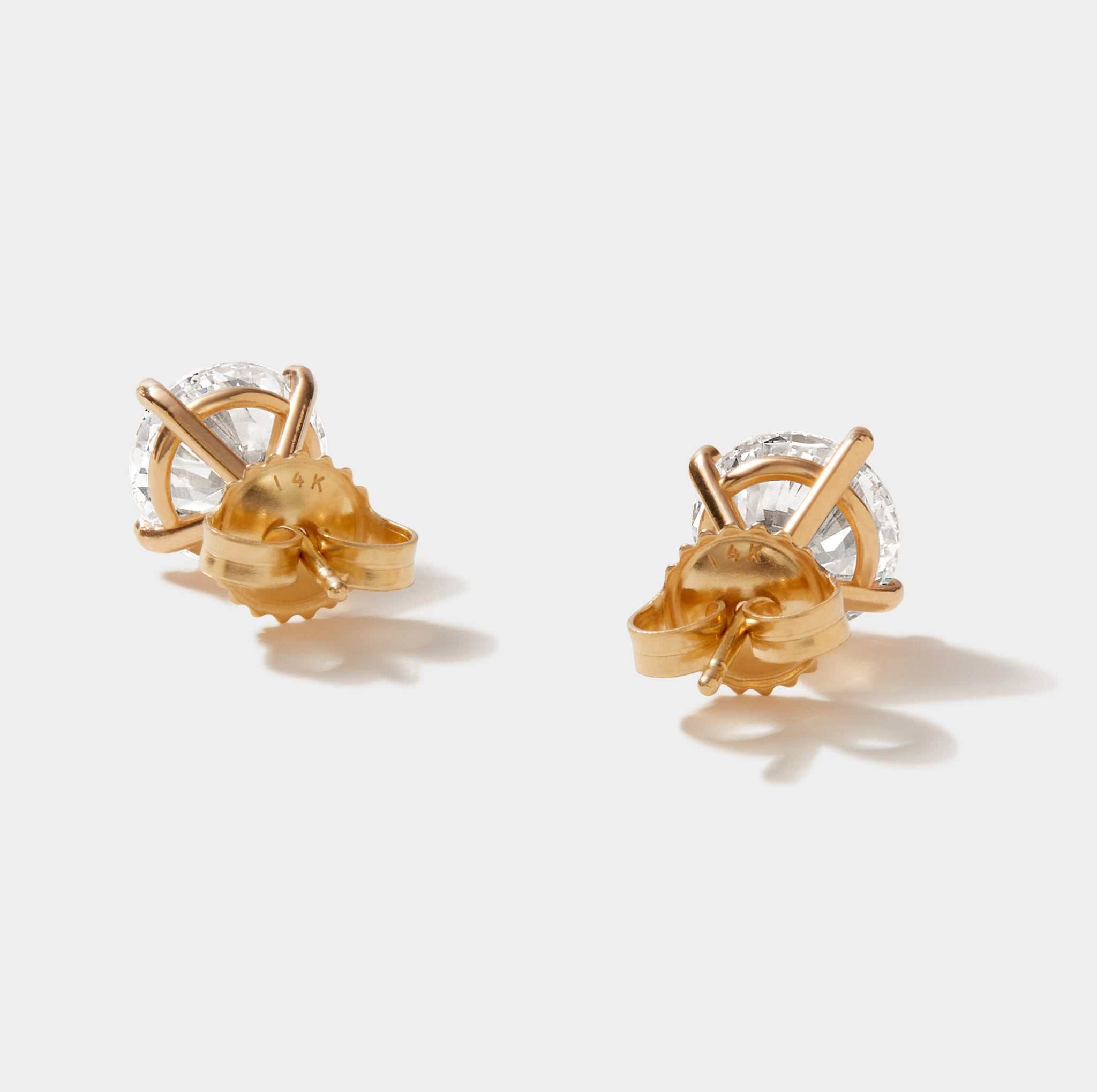 Pair of 3 carat lab grown diamond stud earrings with 14k gold 4-prong martini setting