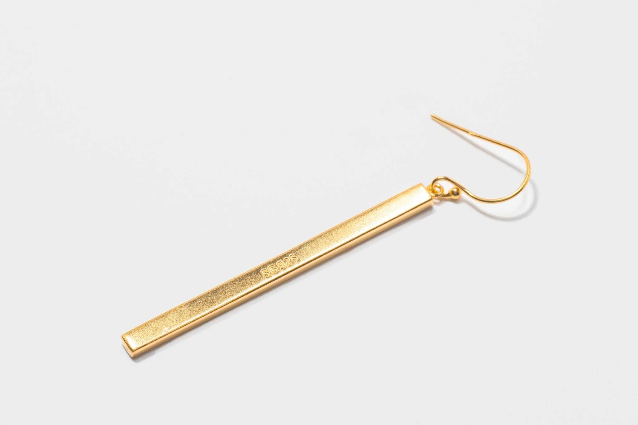 Miladi large gold vermeil earring with long, rectangular geometric design and raw diamond accents