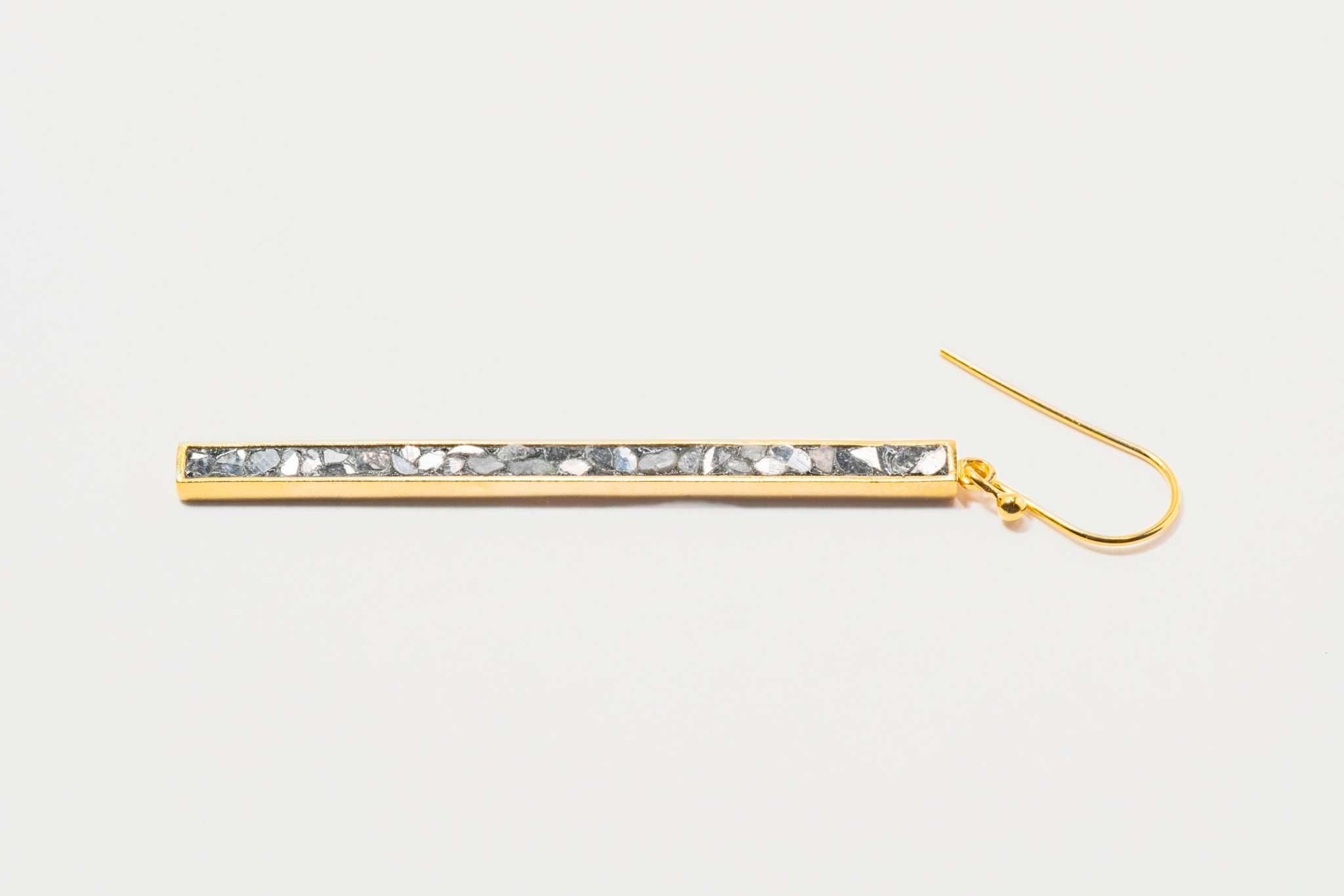 Miladi large gold vermeil earring with a long geometric design and raw uncut diamonds in silver resin.