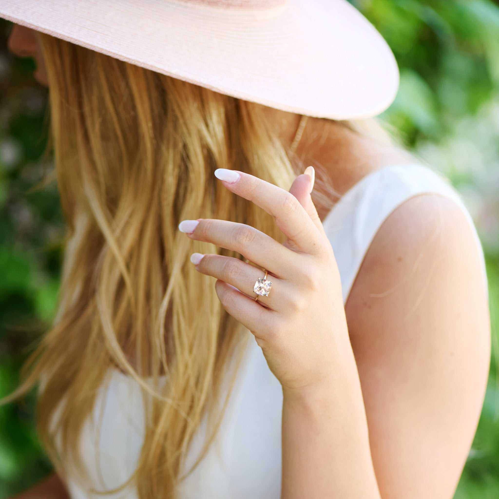 Woman wearing Connecticut Coast Morganite Ring with 10x10mm peach morganite set in 14k gold, styled in natural outdoor setting