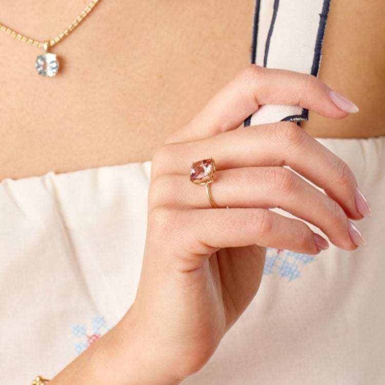 Connecticut Coast Morganite Ring with 10x10mm cushion cut peach morganite set in 14k gold on a woman's hand.