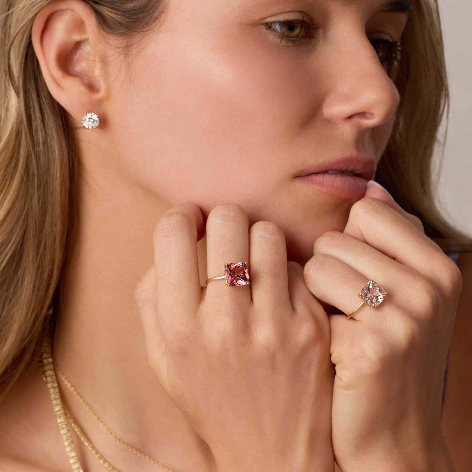 Close-up of a woman wearing 3 carat lab grown diamond stud earrings in 14k gold martini setting