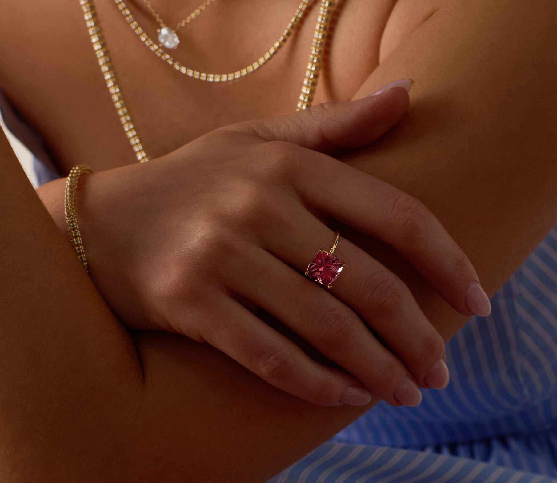 Nantucket Red Ring featuring a cushion-cut pink tourmaline set in 14k solid gold on a woman's hand.