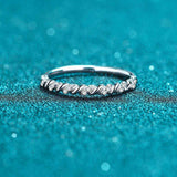 Micro pave croissant shaped moissanite ring in platinum plated S925 sterling silver on blue glitter background