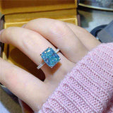 1.8 CTW DEW blue green radiant cut moissanite sterling silver engagement ring on hand