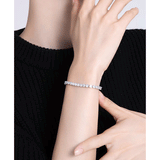 3.5 CTW colorless round brilliant cut moissanite tennis bracelet in adjustable bolo style set in 925 sterling silver worn on wrist