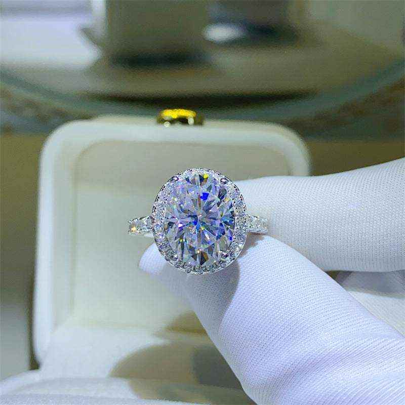 4.2 CTW DEW colorless oval brilliant cut moissanite halo engagement ring in sterling silver