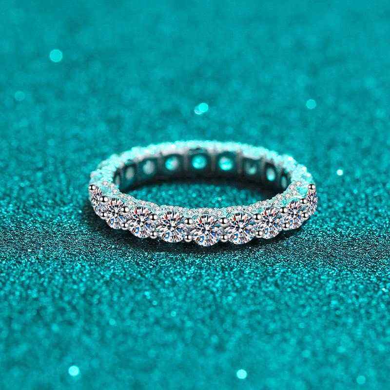 2.1 CTW DEW moissanite eternity wedding band in platinum plated sterling silver with round brilliant cut stones