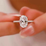 2.1 CTW DEW colorless oval brilliant cut moissanite solitaire engagement ring in sterling silver with pavé accents