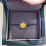 4.75 CTW yellow round brilliant cut moissanite halo engagement ring in sterling silver pavé setting in jewelry box