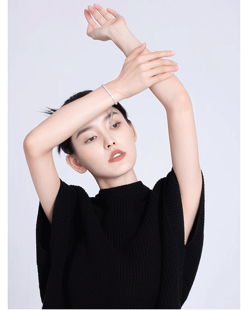 5 CTW DEW colorless round brilliant cut moissanites tennis bolo bracelet in sterling silver on model's wrist