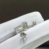 Pair of 1.05 CTW colorless emerald cut rectangular moissanite halo stud earrings in 925 sterling silver with push back closures