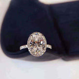 3 CTW colorless oval brilliant cut moissanite halo engagement ring with sterling silver pavé band